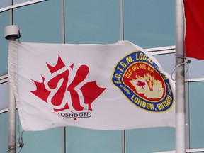 Flags flutter outside the Kellogg Canada plant in London, Ont., Tuesday, Dec. 10, 2013 The plant will close by the end of 2014, resulting in the loss of more than 500 full-time jobs. (THE CANADIAN PRESS/Dave Chidley)