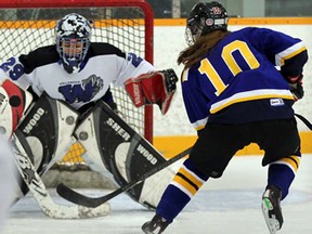 St. Anne's Ashley Maitre, right, scores against Villanova goaltender Alessandra Ceccacci in first peirod action at Tecumseh Arena Wednesday December 11, 2013. (NICK BRANCACCIO/The Windsor Star)