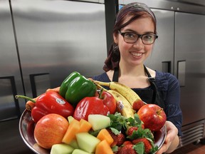 Jordan Meloche from the Green Bean Cafe in downtown Windsor, Ont. uses fresh healthy ingredients to prepare a dish. The business is one of a handful of local eateries that will start serving healthy food for corporate catering. (DAN JANISSE/The Windsor Star)