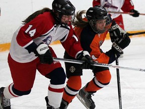 Emma Murray, left, of Holy Names slows down Jaime Cunningham of Sandwich at South Windsor Arena Thursday Dec. 5, 2013.  (NICK BRANCACCIO/The Windsor Star)