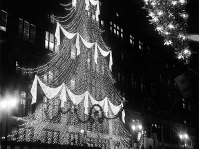 Detroit was set aglow Monday Nov. 23, 1964 night when switches clicked and Christmas lights in the city's business districts sparkled into view. One of the highlights of this year's profusion of light is this tree in front of the J.L. Hudson store. The angel, keeping a wary watch over Christmas shoppers, is attached to a lamp post. (WALTER JACKSON/The Windsor Star)