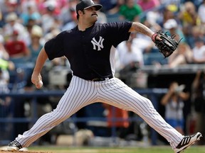 New York Yankees relief pitcher Joba Chamberlain warms up before a game in Tampa, Fla. Reports say the Detroit Tigers and Chamberlain have agreed to terms on a one-year contract. (AP Photo/Kathy Willens, File)