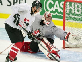 Team Canada goaltender Jake Paterson, right, makes a save on Tecumseh's Kerby Rychel during practice at the IIHF World Junior Hockey Championships in Malmo, Sweden on Wednesday December 25, 2013. (THE CANADIAN PRESS/ Frank Gunn)