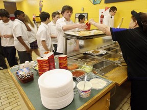 In this file photo, staff served students in the cafeteria of Holy Names on January 21, 2010 before the provincewide ban on unhealthy foods in schools. (TYLER BROWNBRIDGE / The Windsor Star)