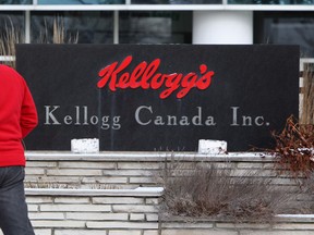 A man walks by the Kellogg's Canada plant in London, Ont., Tuesday, Dec. 10, 2013 The plant will close by the end of 2014, resulting in the loss of more than 500 full-time jobs. (THE CANADIAN PRESS/Dave Chidley)