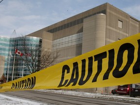 Caution tape hangs across a closed parking lot at the Kellogg's Canada plant is shown in London, Ont., Tuesday, Dec. 10, 2013 The plant will close by the end of 2014, resulting in the loss of more than 500 full-time jobs. (THE CANADIAN PRESS/Dave Chidley)