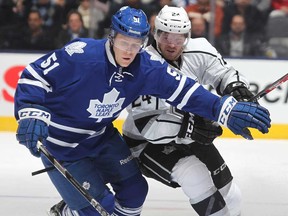 Colin Fraser, right, of the Los Angeles Kings battles Jake Gardiner of the Maple Leafs at the Air Canada Centre on December 11, 2013 in Toronto. (Claus Andersen/Getty Images)