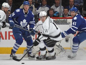 Anze Kopitar, centre, of the Los Angeles Kings skates with the puck against the Toronto Maple Leafs at the Air Canada Centre on December 11, 2013 in Toronto. (Claus Andersen/Getty Images)