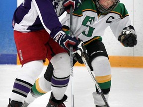 Andy Harkus, left, of Assumption battles Alex Simard of Lajeunesse in WECSSAA boys hockey action from South Windsor Arena December 9, 2013. (NICK BRANCACCIO/The Windsor Star)