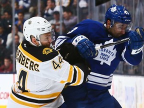 Toronto's Nazem Kadri, right, battles Boston's Dennis Seidenberg during NHL action at the Air Canada Centre December 8, 2013 in Toronto, Ontario, Canada.  (Photo by Abelimages/Getty Images)