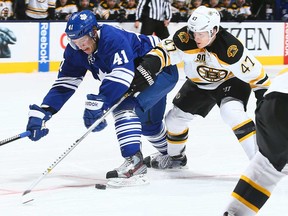 Toronto's Nikolai Kulemin, left, battles Boston's Torey Krug during NHL action at the Air Canada Centre December 8, 2013 in Toronto, Ontario, Canada.  (Photo by Abelimages/Getty Images)