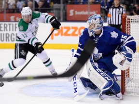 Maple Leafs goalie Jonathan Bernier, right, watches for the puck as Dallas' Ray Whitneytakes a shot shot during first period in Toronto on Thursday, December 5, 2013. (THE CANADIAN PRESS/Frank Gunn)