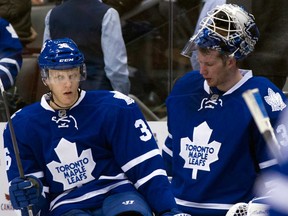 Maple Leafs goaltender James Reimer, left, and defenceman Carl Gunnarsson come off the bench following the Leafs 3-1 loss to the Florida Panthers in Toronto Tuesday December17, 2013. (THE CANADIAN PRESS/Frank Gunn)