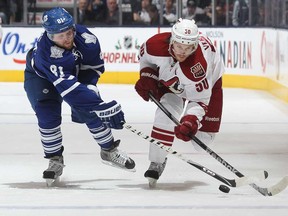 Phoenix's Antoine Vermette, right, battles Toronto's Phil Kessel at the Air Canada Centre on December 19, 2013 in Toronto, Ontario, Canada. (Claus Andersen/Getty Images