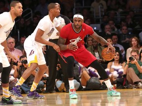 Miami's LeBron James, right, battles Wesley Johnson of the Los Angeles Lakers at Staples Center on December 25, 2013 in Los Angeles, California.  (Stephen Dunn/Getty Images)