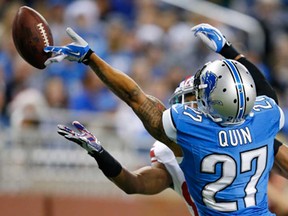 Detroit strong safety Glover Quin, right, breaks up a pass intended for New York wide receiver Rueben Randle Sunday, Dec. 22, 2013, in Detroit. (AP Photo/Rick Osentoski)