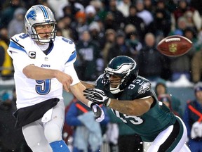 Detroit OB Matthew Stafford, left, passes under pressure from Philadelphia's Mychal Kendricks Sunday, Dec. 8, 2013, in Philadelphia. (AP Photo/Matt Rourke)