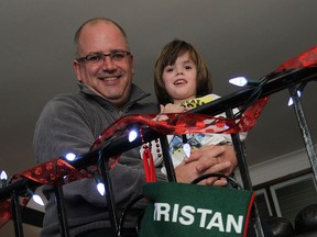 In this file photo, Chris Savard, general manager of Devonshire Mall, and his son Tristan, are photographed at their home in Stoney Point on Wednesday, December 4, 2013. autistic kids will be getting some special time with the mall santa after closing next Sunday.                (TYLER BROWNBRIDGE/The Windsor Star)