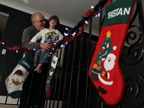 Chris Savard, general manager of the Devonshire Mall, and his son Tristan are photographed at their home in Stoney Point on Wednesday, December 4, 2013. Autistic kids will be getting some special time with the mall santa after closing next Sunday.                (TYLER BROWNBRIDGE/The Windsor Star)