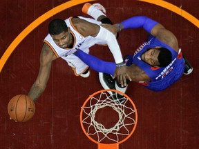 Cleveland's Kyrie Irving, left, shoots against Detroit's Andre Drummond Monday, Dec. 23, 2013, in Cleveland. (AP Photo/Mark Duncan)