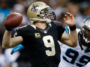 Saints QB Drew Brees, left, throws a pass against the Carolina Panthers on December 8, 2013 in New Orleans. The Panthers host the Saints Sunday. (Chris Graythen/Getty Images)