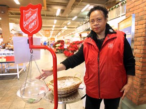 Rhoda Taylor mans the Salvation Army kettle at the Zehrs store at Tecumseh and Lauzon in Windsor, Ont. on Wed. Dec. 11, 2013. After receiving complaints about the use of the traditional bells, she was forced to participate in the Christmas season fundraiser without them. (DAN JANISSE/The Windsor Star)