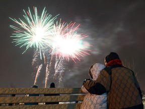 Richard Lloyd keeps his step daughter Rosemary O'Dowd warm as they watch the fireworks at Lanspeary Park in Windsor on Tuesday, December 31, 2013. (TYLER BROWNBRIDGE/The Windsor Star)