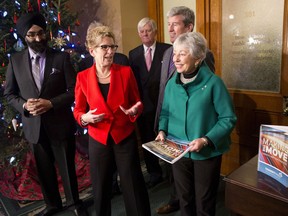 Ontario Premier Kathleen Wynne, centre left, stands with Anne Golden, chair of the transit investment strategy advisory panel. (THE CANADIAN PRESS/Chris Young)