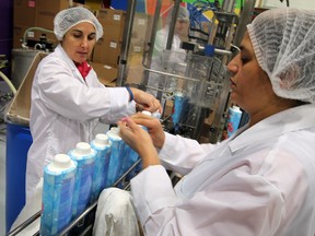 Fanica Nafornita, left, and Jasvir Mudan package bubble bath under the label Aleeda at Pax-All Manufacturing on Dec. 13, 2013. (NICK BRANCACCIO/The Windsor Star)