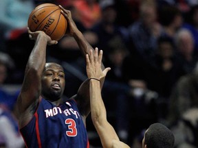 Pistons guard Rodney Stuckey, left, takes a shot against Philadelphia's Michael Carter-Williams Sunday, Dec. 1, 2013, in Auburn Hills, Mich. Stuckey scored 17 points in a 115-100 win over the 76ers. (AP Photo/Duane Burleson)
