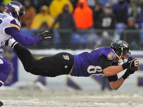 Ravens tight end Dennis Pitta, right, makes a catch during the game against the Minnesota Vikings December 8, 2013 in Baltimore. The Ravens face the Lions Monday night in Detroit. (Larry French/Getty Images)