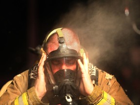 Steam comes on the head of a firefighter at the scene of a fire at the Tecumseh Roadhouse restaurant on County Rd. east of Lauzon Rd., Monday, Feb. 4, 2013. (DAN JANISSE/The Windsor Star)