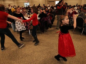 Bella Casey (right) shows off her dance moves during the annual Salvation Army Christmas Dinner at the St. Clair Centre for the Arts in Windsor on Wednesday, December 18, 2013.                   (TYLER BROWNBRIDGE/The Windsor Star)