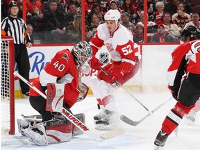 Ottawa goalie Robin Lehner, left, makes a save against Detroit's Jonathan Ericsson, centre, as Senators Erik Karlsson and Jared Cowen right look on at the Canadian Tire Centre on December 1, 2013 in Ottawa, (Jana Chytilova/Getty Images)
