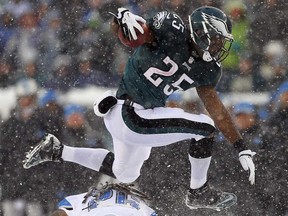 Eagles running back LeSean McCoy, top, hurdles Lions safety Louis Delmas for a touchdown at Lincoln Financial Field on December 8, 2013 in Philadelphia. (Rich Schultz /Getty Images)