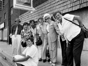 Owner Margaret Stanley sits on the curb in front of her family's tavern on Aug. 12, 1991 with some long-time patrons gathered for the bar's last day. (TED RHODES/The Windsor Star)