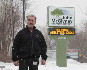Lloyd Ayotte, facility manager for the John McGivney Children's Centre in Windsor, Ontario is hoping someone will return the extension cord stolen from the front lawn of the Matchette Road centre.  The extension cord ran power to the Christmas lights on a tree in front. (JASON KRYK/The Windsor Star)
