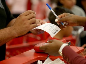 A customer prepares to sign a credit card slip at a Target store on Dec. 19, 2013 in Miami, Fl. Target announced that about 40 million credit and debit card accounts of customers who made purchases by swiping their cards at terminals in its U.S. stores between Nov. 27 and Dec. 15 may have been stolen.  ( Joe Raedle/Getty Images)