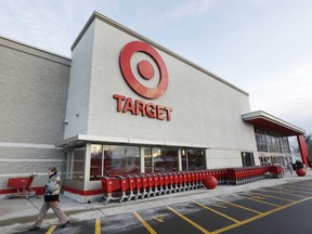 A passer-by walks near an entrance to a Target retail store Thursday, Dec. 19, 2013 in Watertown, Mass. Target says that about 40 million credit and debit card accounts may have been affected by a data breach that occurred just as the holiday shopping season shifted into high gear. (Steven Senne/Associated Press)