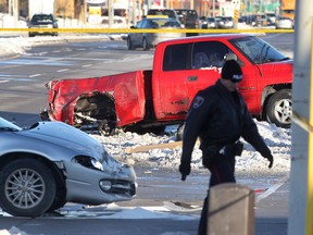 A Windsor police officer is shown at the scene of a fatal collision at the intersection of Tecumseh Rd. and Rose-Ville Garden Dr. on Mon. Dec. 16, 2013. in Windsor, ON. A pedestrian was struck and killed. A truck and a car were involved in the accident. (DAN JANISSE/The Windsor Star)