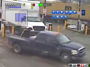 A dark blue Dodge Ram Dual Axle pickup truck is seen in this surveillance photo, taken at a gas station in the 400 block of Talbot Street West in Leamington on Dec. 2, 2013. (Courtesy of Essex County OPP)