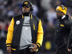 Pittsburgh head coach Mike Tomlin, left, watches from the sideline in the NFL game against the Baltimore Ravens, Thursday, Nov. 28, 2013, in Baltimore. (AP Photo/Gail Burton)