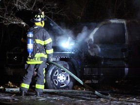 Firefighters extinguish a truck that was on fire in Optimist Memorial Park in Windsor on Monday, December 30, 2013. The Truck was found in the park on fire. No one was in the vehicle when firefighters arrived.                        (TYLER BROWNBRIDGE/The Windsor Star)