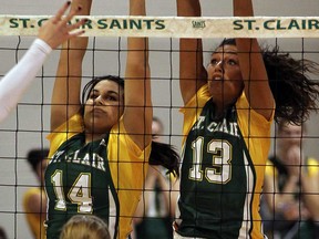 St. Clair's Kaleigh MacKenzie, left, and Samantha Bueckert try for a block against Fanshawe in volleyball action from St. Clair College Wednesday December 4, 2013.  (NICK BRANCACCIO/The Windsor Star)
