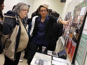 Melissa Andrade gives Mary Ann Cuderman, left, a tour of her group project at the University of Windsor on Tuesday, December 10, 2013. Students completed and presented their vision for vacant properties in the West End.                   (TYLER BROWNBRIDGE/The Windsor Star)