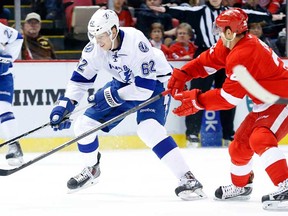 Lightning defenceman Andrej Sustr, centre, skates against Detroit's Tomas Tatar in Detroit, Sunday, Dec. 15, 2013. (AP Photo/Paul Sancya)