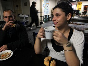 Happy to be in from the cold, Stephanie Law, 26, shares a coffee and bagel with Randy Kaungh, left, at Street Help Homeless Services on Wyandotte Street East Friday, Jan. 3, 2014. (NICK BRANCACCIO/The Windsor Star)