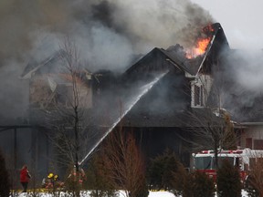 Kingsville fire crews work to extinguish a house fire on Road 8 East between North Talbot Road and Graham Side Road Saturday, Jan. 11, 2014.  No injuries were reported.  (DAX MELMER/The Windsor Star)