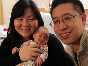 Mother Kathy Ly holds her newborn son, Aurin Chang, as father Steven Chang smiles at Met Campus, Wednesday, Jan. 1, 2014.  Aurin, 6 lbs., was the first child born in Essex County in 2014, at 2:40 a.m. at Windsor Regional Hospital Met Campus. (NICK BRANCACCIO/The Windsor Star)