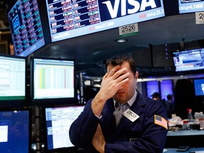 Specialist Vincent Surace reacts to the almost two per cent drop in stocks on the New York Stock Exchange Friday. (AP Photo/Jason DeCrow)